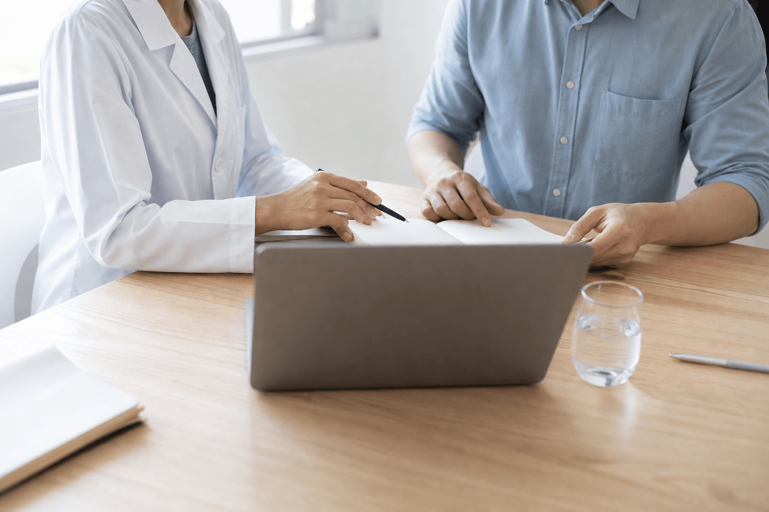 A doctor and an engineer working together at a bright table